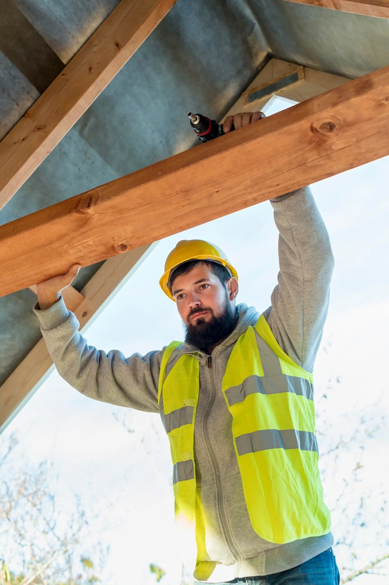 Low-angle view of a male carpenter at work.