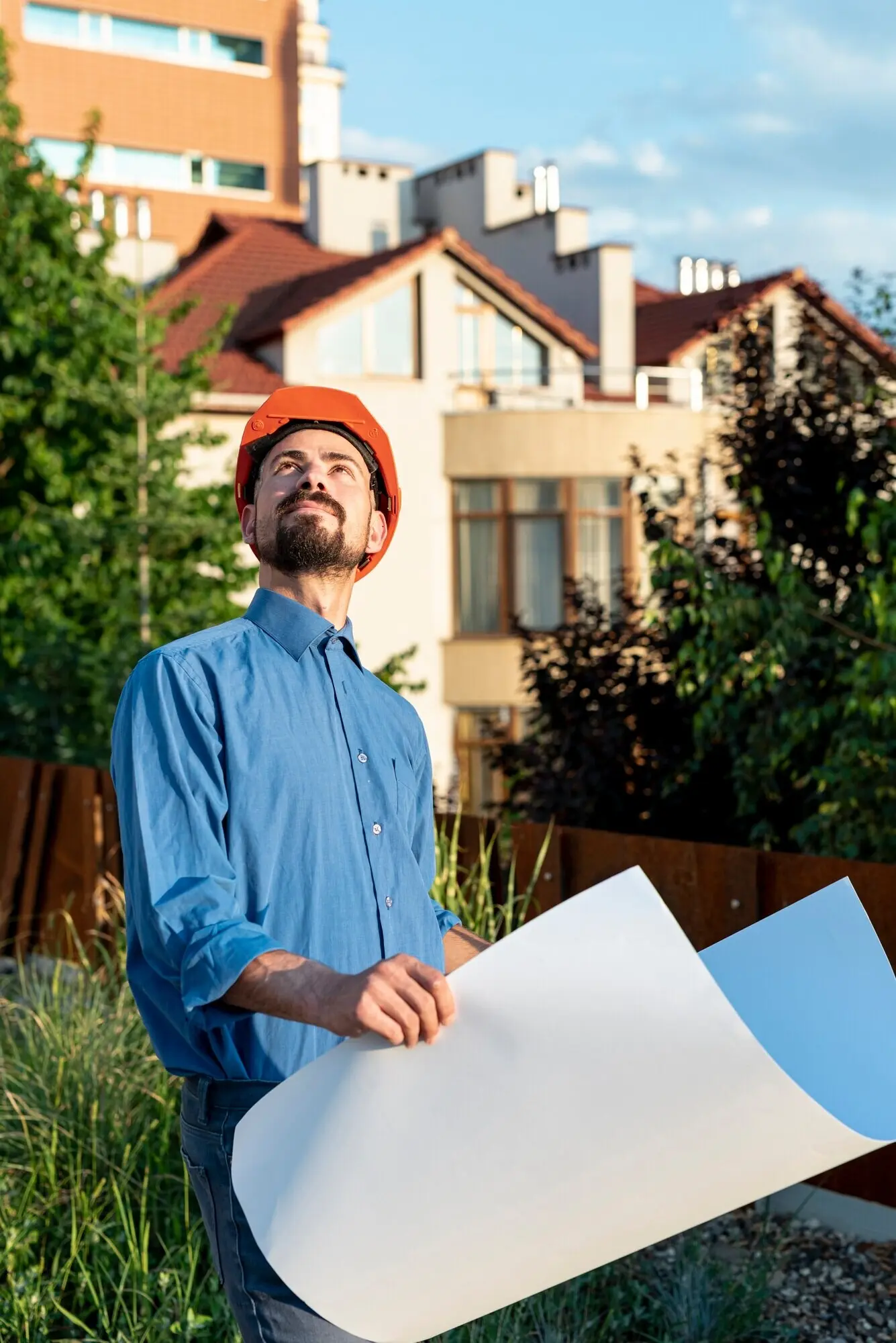 Front-facing view of an architect with blueprints.