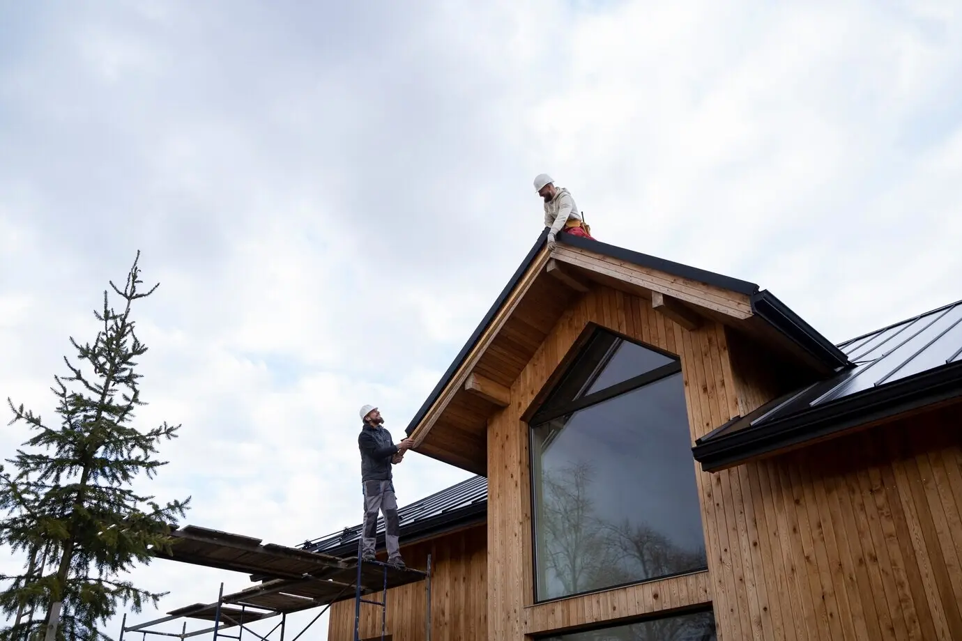 Long shot of men working together on a roof