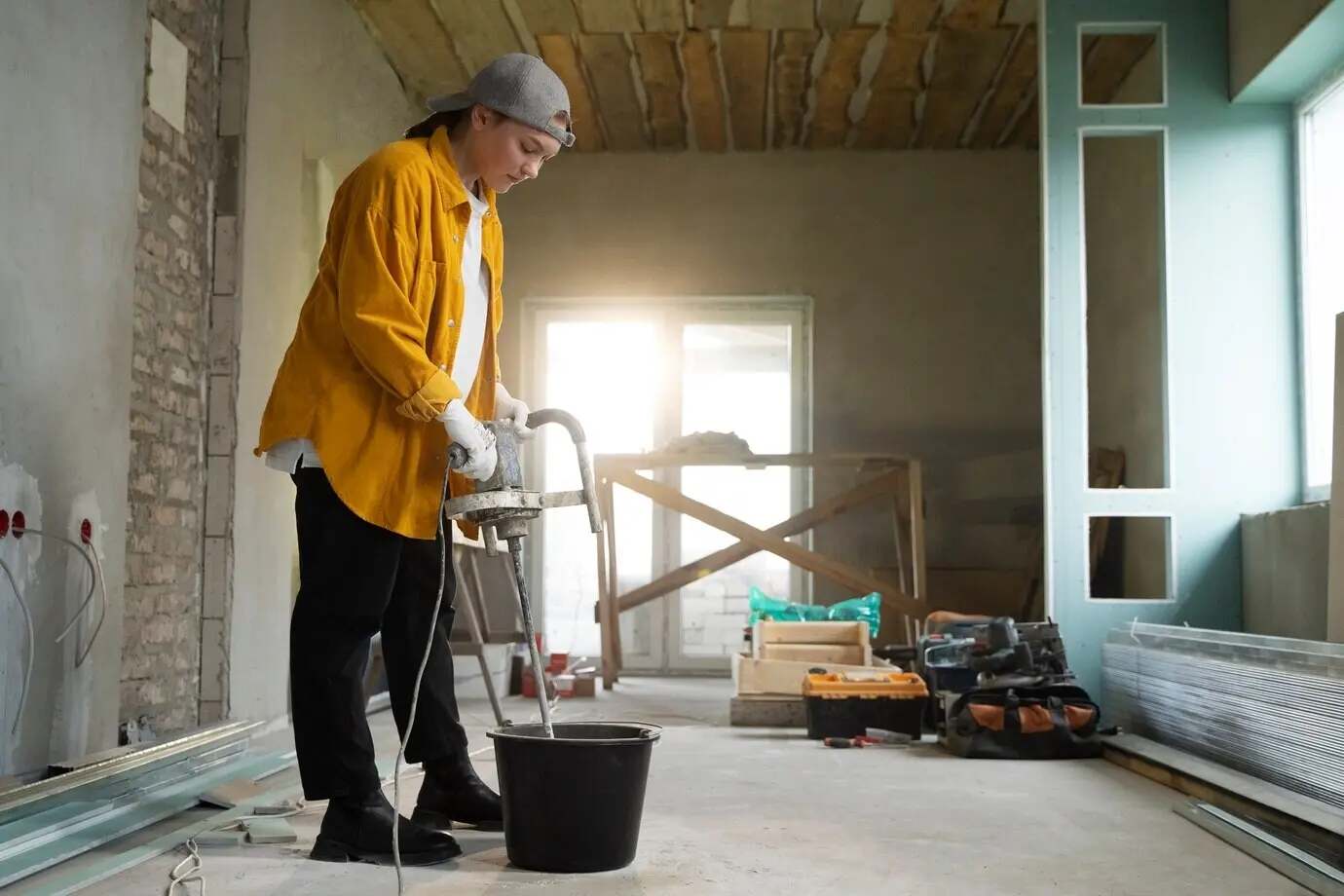 A tiler working on an apartment renovation.